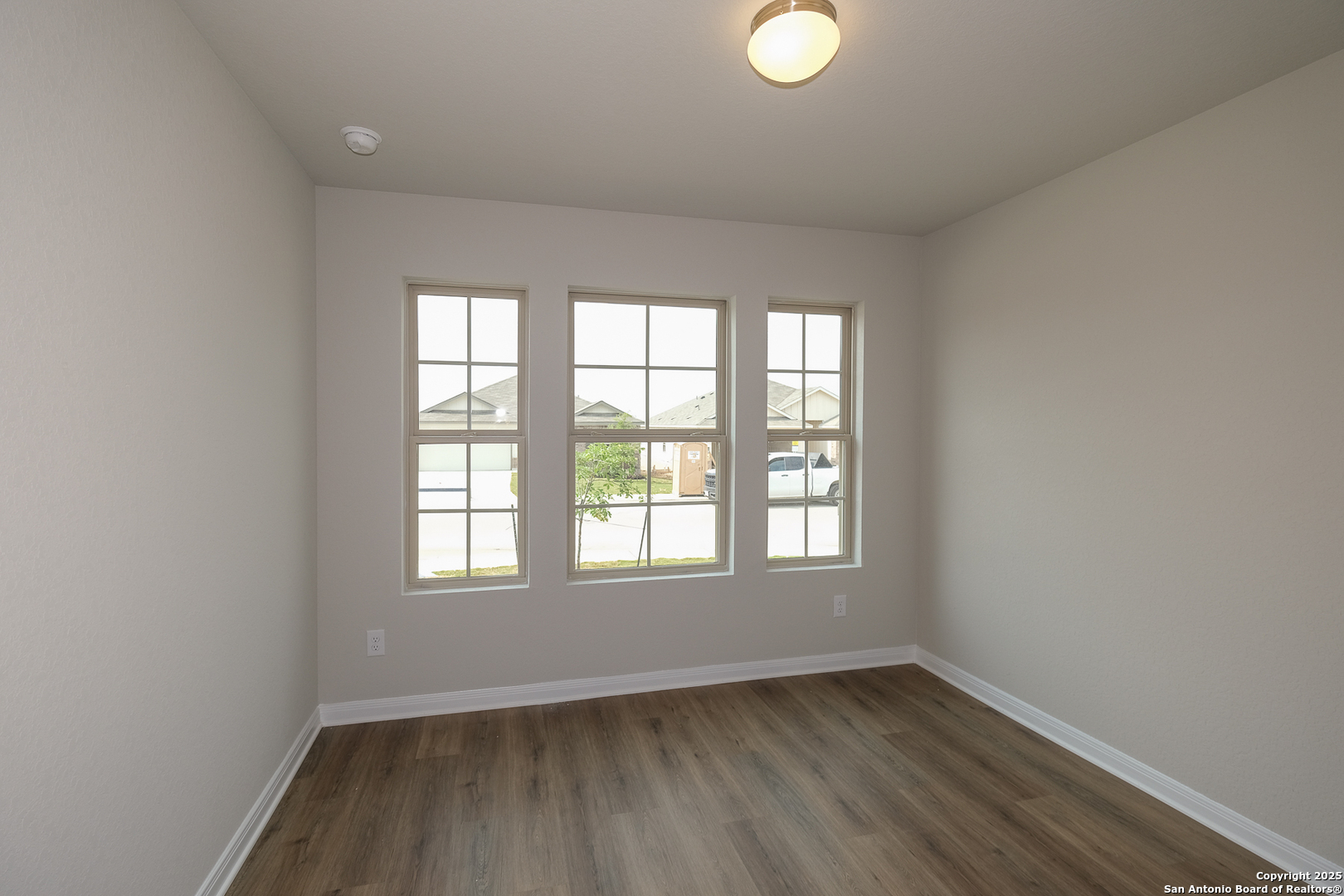 1124 Water Valley Seguin, TX 78155 - Photo 22 of 39 an empty room with wooden floor and windows