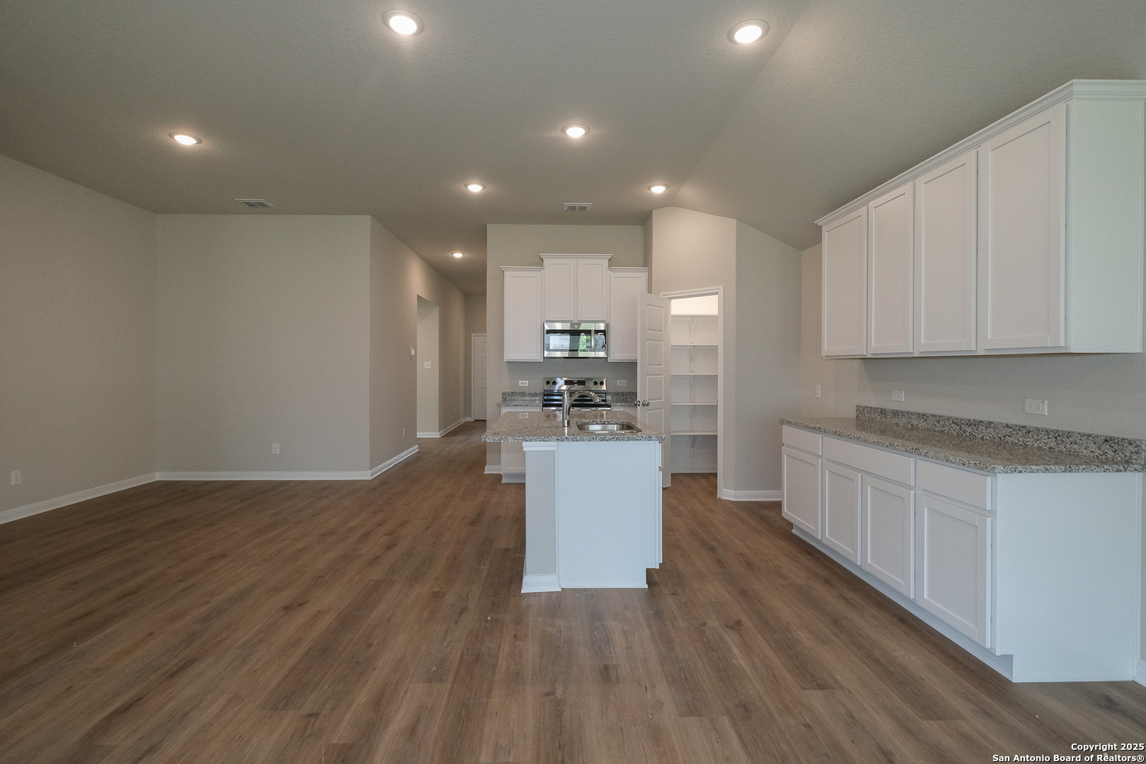 1124 Water Valley Seguin, TX 78155 - Photo 7 of 39 a kitchen with a sink wooden floor and stainless steel appliances