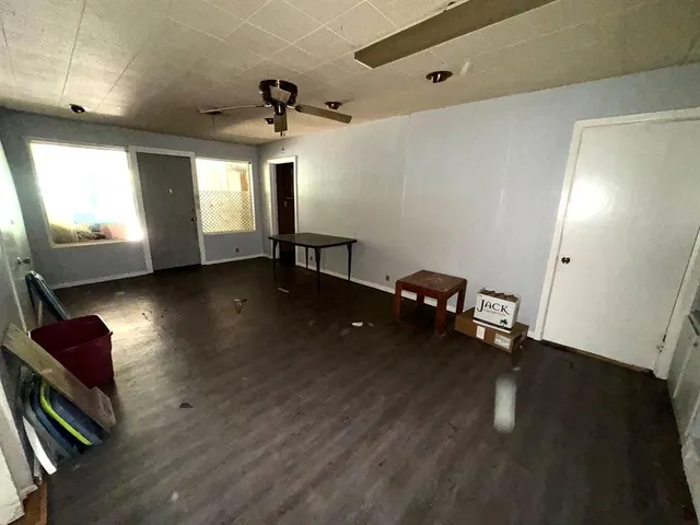 a view of a livingroom with furniture and a window