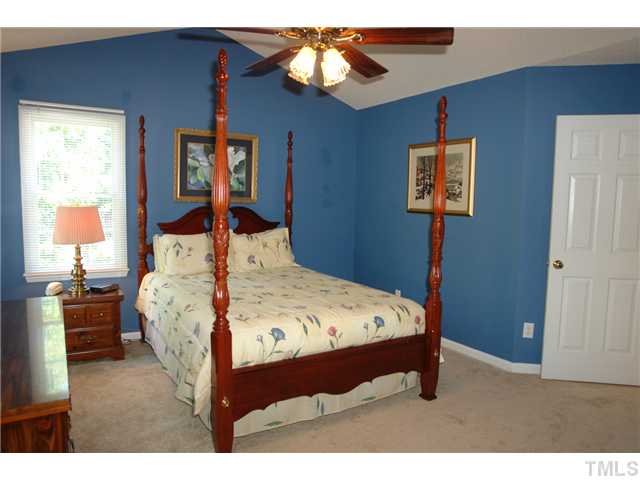 12205 Freemont Lane Raleigh, NC 27613 - Photo 13 of 25 a bedroom with a bed and a painting on the wall