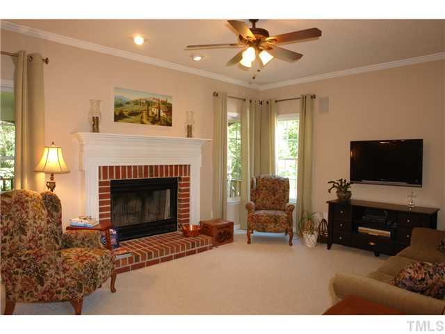 12205 Freemont Lane Raleigh, NC 27613 - Photo 4 of 25 a living room with furniture and a fireplace