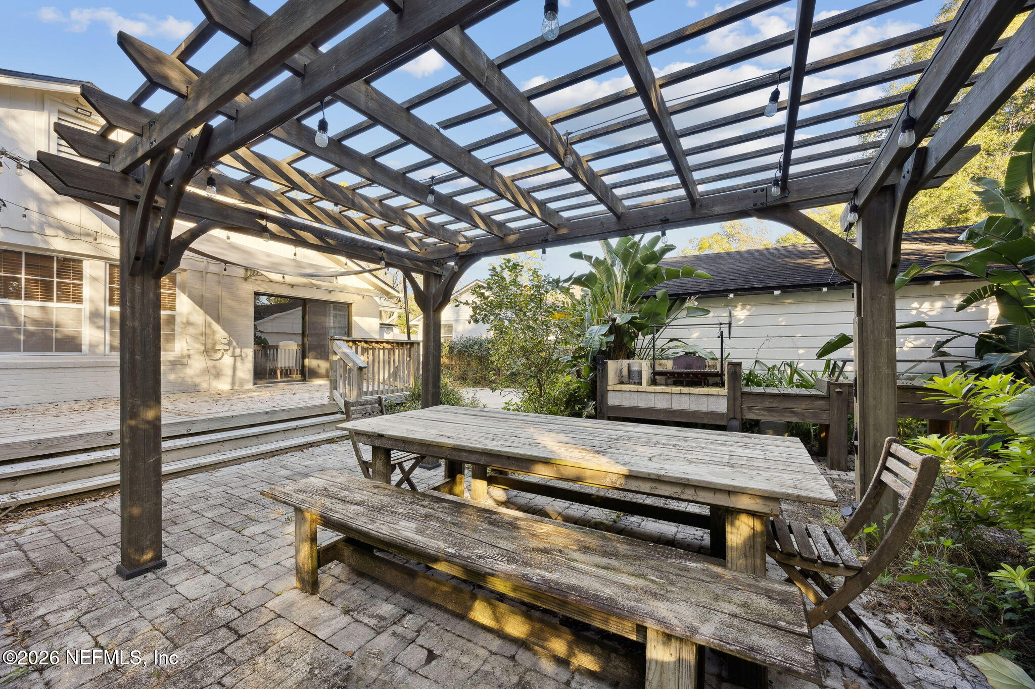 1626 Brookwood Road Jacksonville, FL 32207 - Photo 34 of 98 a view of a patio with a table and chairs with wooden floor and fence
