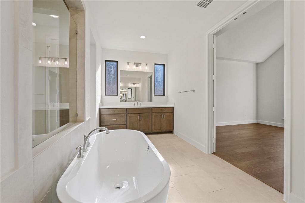 4626 Rillstone Road Midlothian, TX 76065 - Photo 17 of 40 Bathroom featuring a freestanding tub, vanity, light tile patterned floors, recessed lighting, and a shower