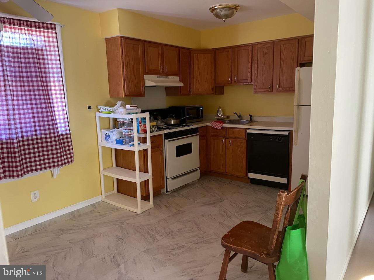 a kitchen with a stove a sink and a microwave