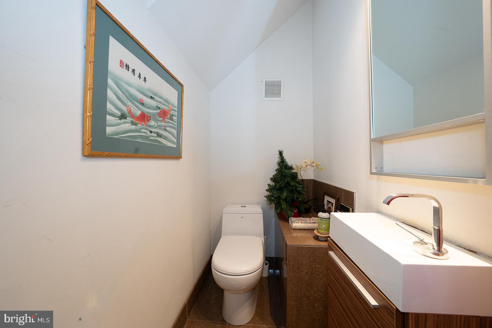 715 Shirley Street, Unit A Philadelphia, PA 19130 - Photo 12 of 24 a bathroom with a toilet a sink and mirror