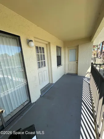 a view of a livingroom with furniture and staircase