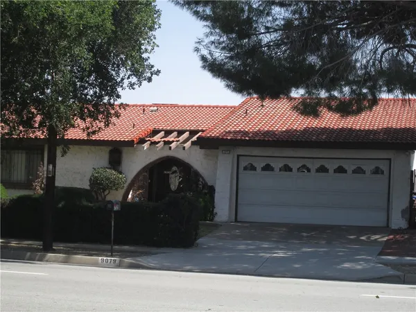 a front view of a house with parking area