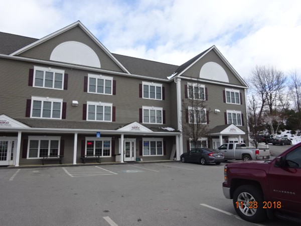 32 Pommogussett Road, Unit 8 Rutland, MA 01543 - Photo 12 of 15 a front view of a building with many windows