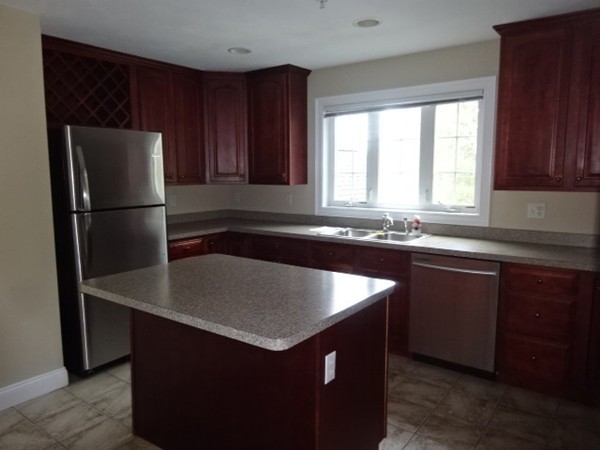 32 Pommogussett Road, Unit 8 Rutland, MA 01543 - Photo 9 of 15 a kitchen with granite countertop a refrigerator and a sink