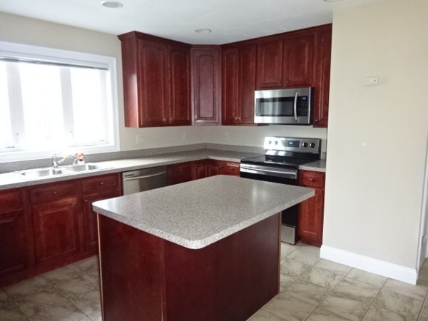 32 Pommogussett Road, Unit 8 Rutland, MA 01543 - Photo 10 of 15 a kitchen with a sink a microwave and cabinets