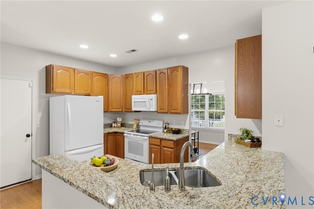 7807 Clover Ridge Place Chesterfield, VA 23832 - Photo 10 of 51 Kitchen featuring L-shaped granite countertops, wo