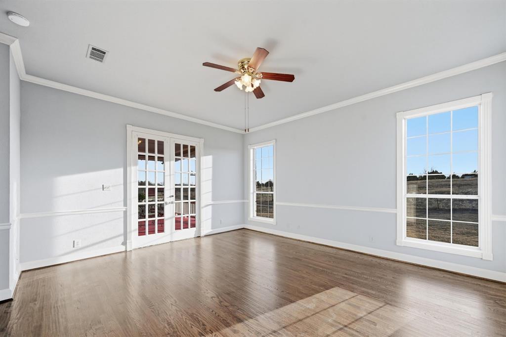 707 Cullins Road Rockwall, TX 75032 - Photo 18 of 40 an empty room with windows and cabinet