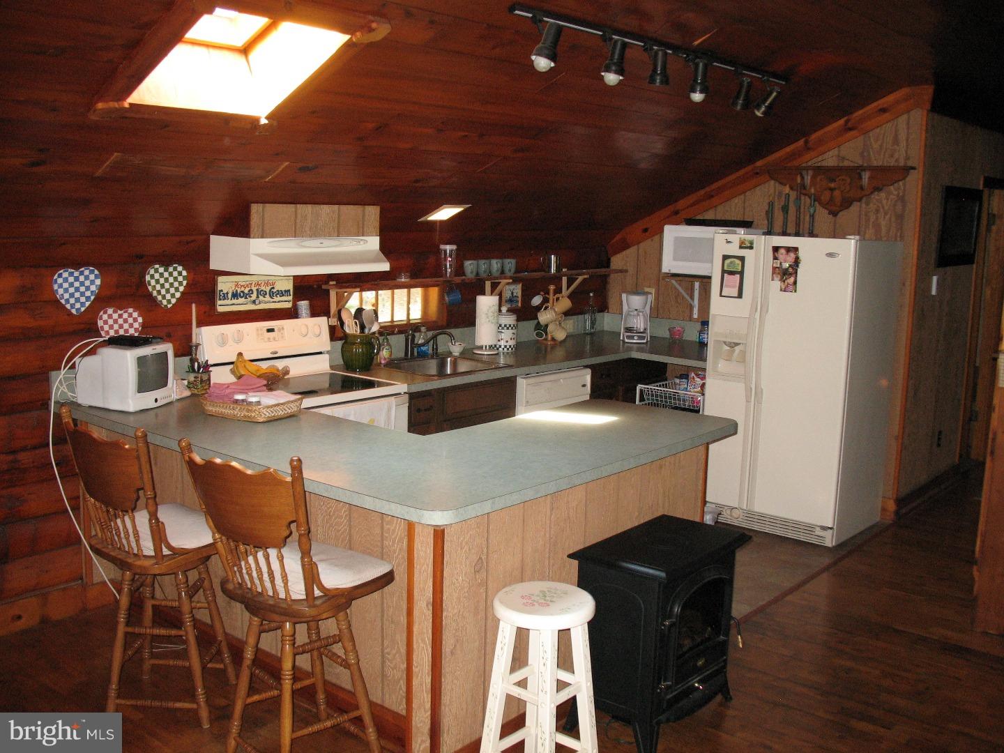 297 Jericho Road Quinton, NJ 08079 - Photo 5 of 16 a kitchen with stainless steel appliances kitchen island granite countertop a table chairs and a refrigerator