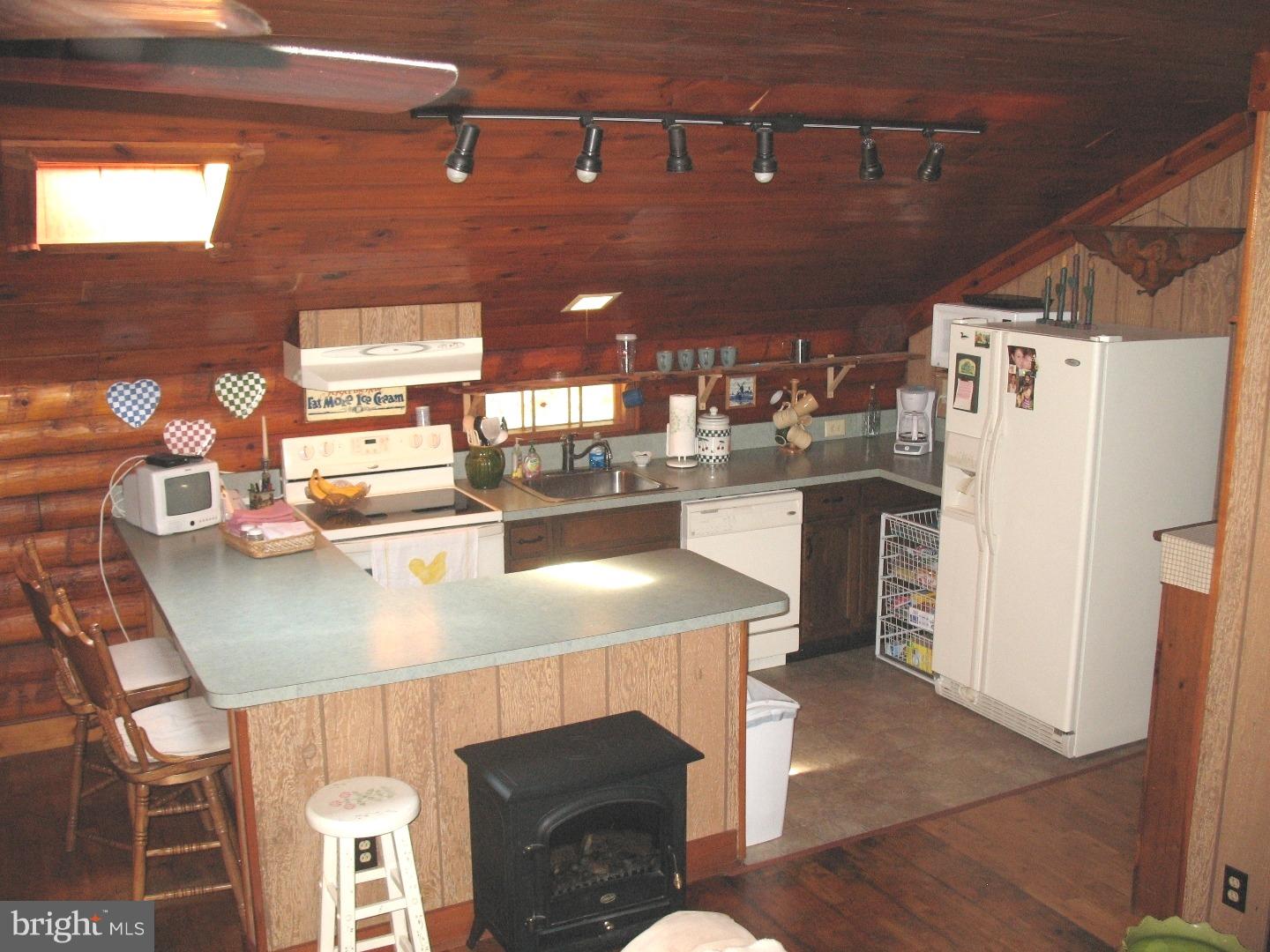 297 Jericho Road Quinton, NJ 08079 - Photo 7 of 16 a kitchen with stainless steel appliances granite countertop a table chairs and a refrigerator