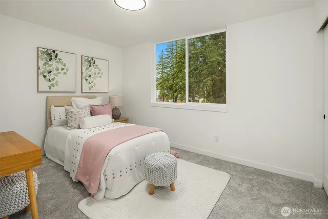 a bedroom with a bed and painting on the wall