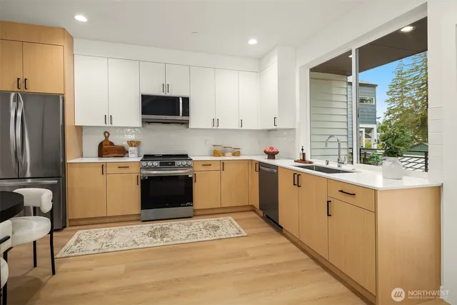 a kitchen with white cabinets and white appliances