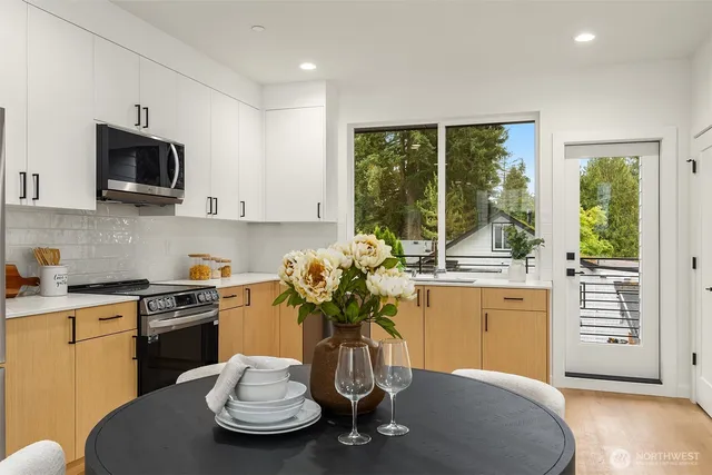 a kitchen with a stove a sink and a white cabinets