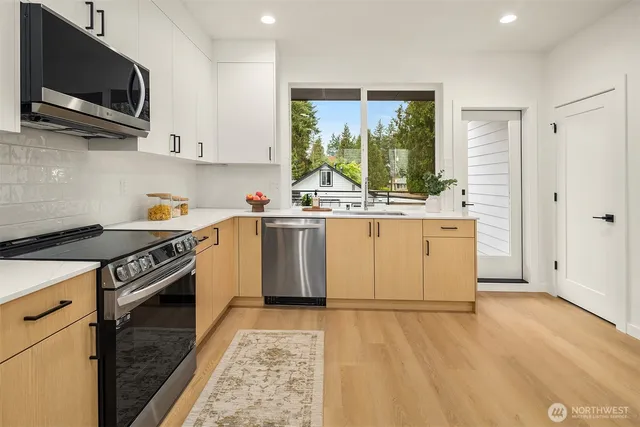 a kitchen with a stove a sink and a microwave