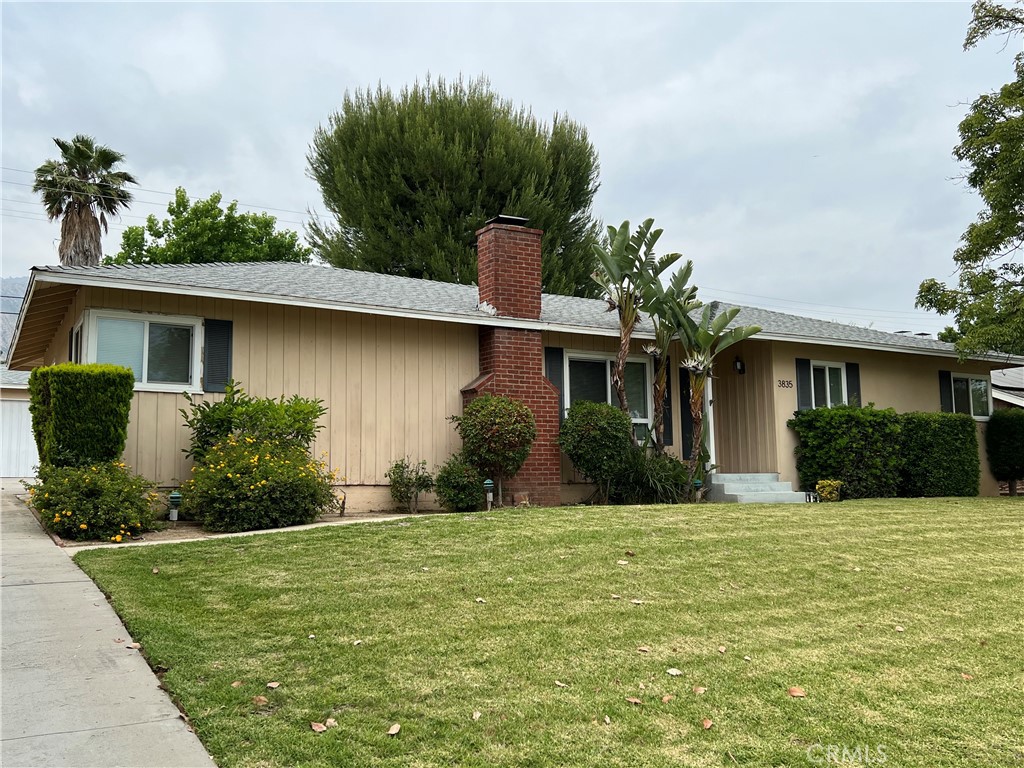 a front view of house with yard and green space