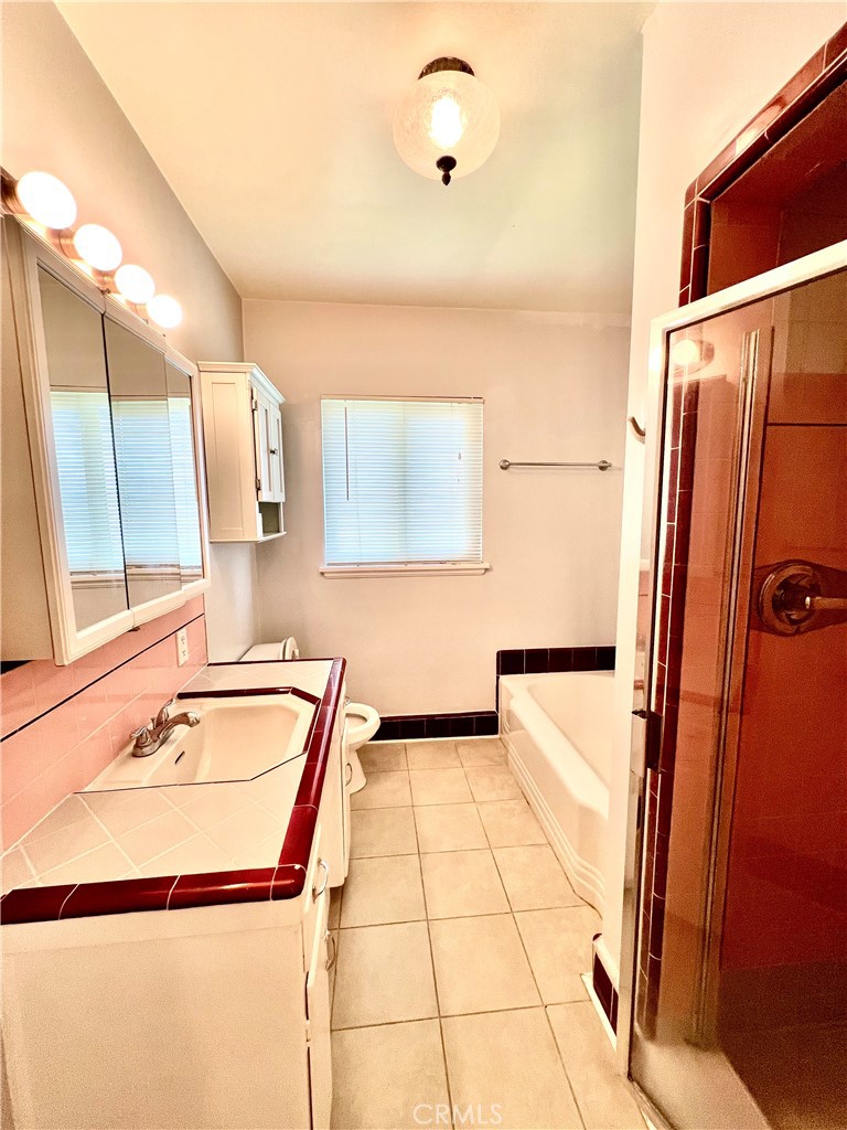 3835 Canfield Road Pasadena, CA 91107 - Photo 11 of 15 a bathroom with a tub sink and mirror