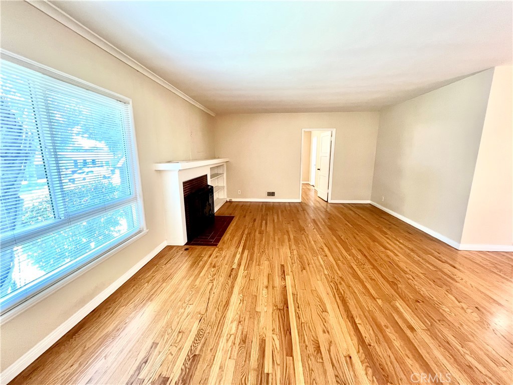 3835 Canfield Road Pasadena, CA 91107 - Photo 3 of 15 a view of empty room with wooden floor and fan