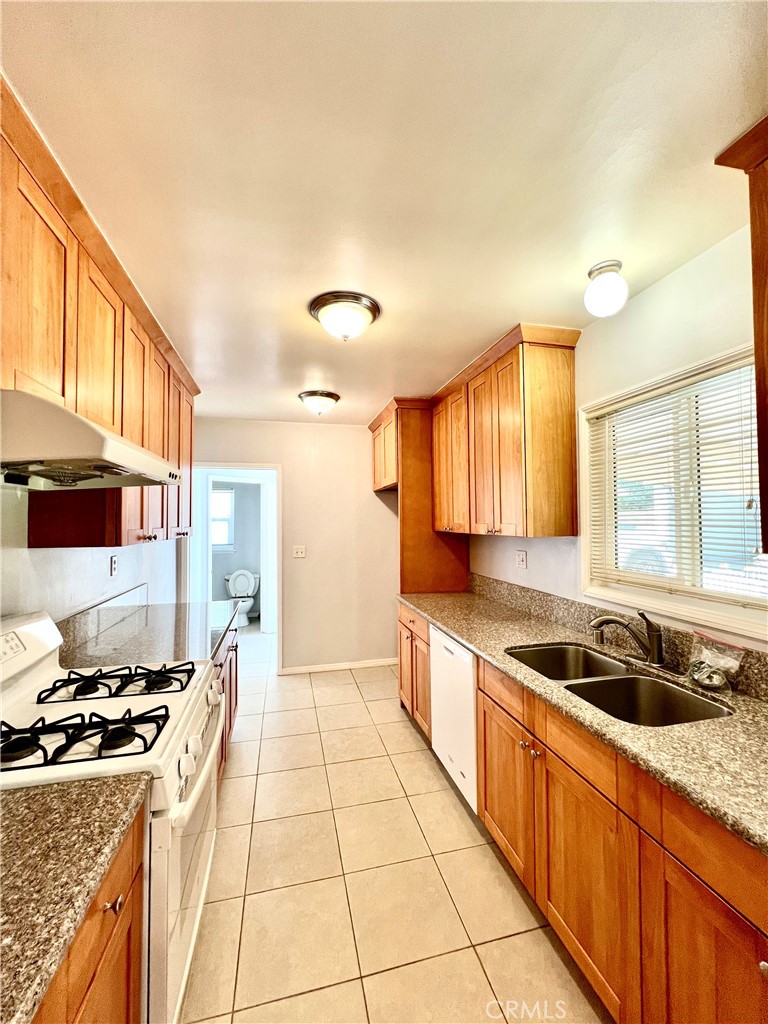 3835 Canfield Road Pasadena, CA 91107 - Photo 4 of 15 a kitchen with a sink and a stove top oven