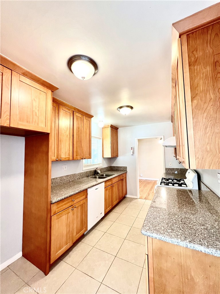 3835 Canfield Road Pasadena, CA 91107 - Photo 5 of 15 a kitchen with stainless steel appliances granite countertop a sink and a stove