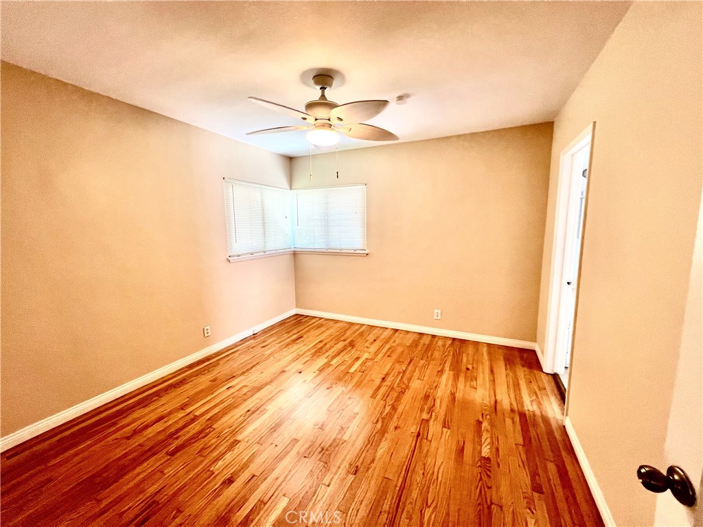 3835 Canfield Road Pasadena, CA 91107 - Photo 6 of 15 a view of an empty room with wooden floor and a window