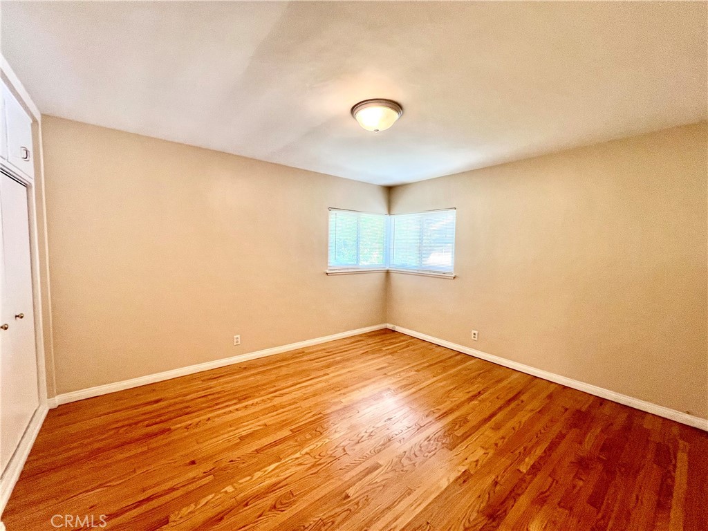 3835 Canfield Road Pasadena, CA 91107 - Photo 9 of 15 a view of an empty room with wooden floor and a window