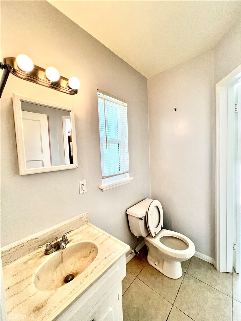 3835 Canfield Road Pasadena, CA 91107 - Photo 10 of 15 a bathroom with a toilet a sink and mirror