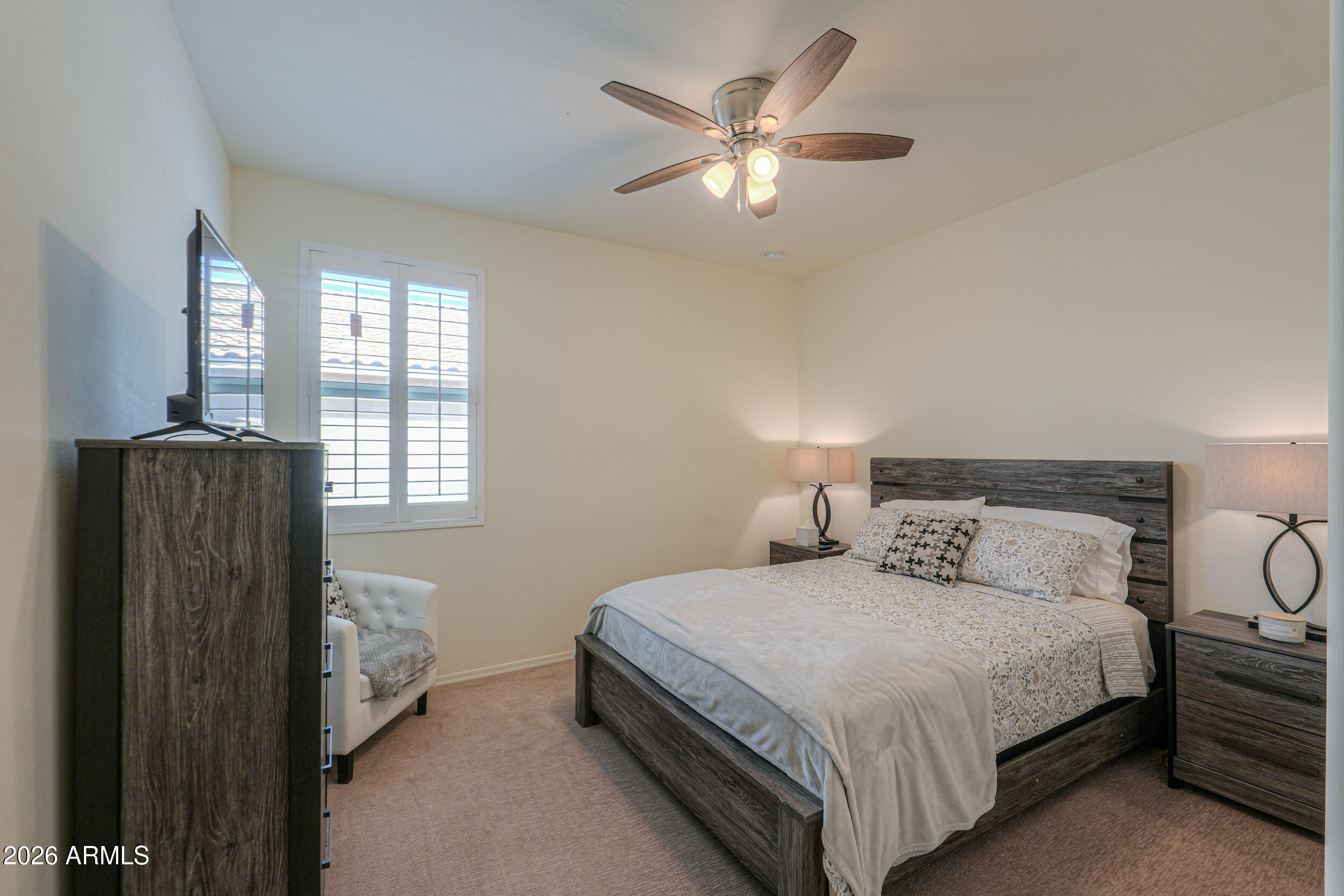 42085 West Cribbage Road Maricopa, AZ 85138 - Photo 17 of 35 a bedroom with a bed and a chandelier