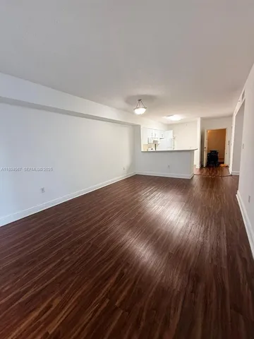 a view of a room with wooden floor
