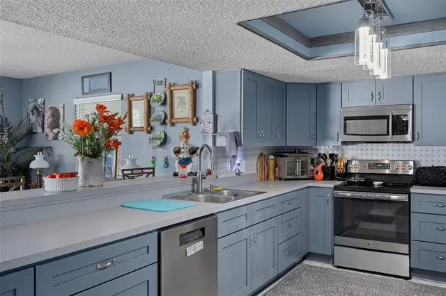 a kitchen with stainless steel appliances a refrigerator stove and microwave