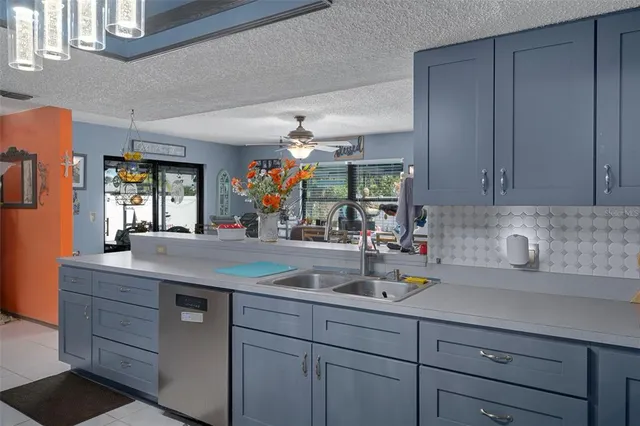 a kitchen with stainless steel appliances granite countertop a sink and a refrigerator