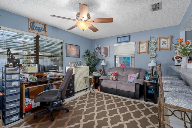 a living room with furniture a chandelier and a dining table