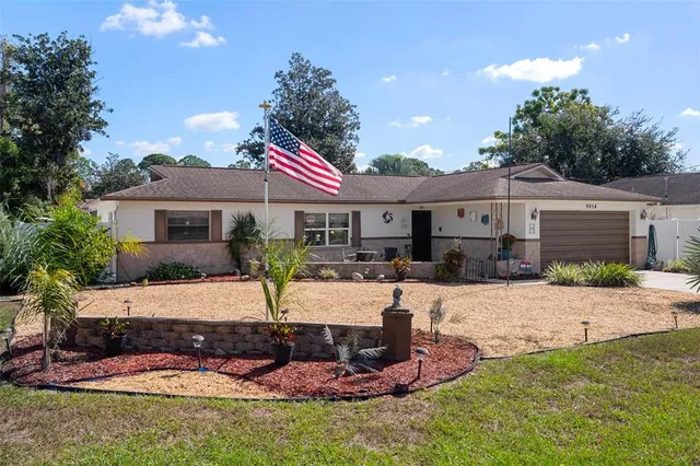 a front view of a house with yard patio and green space