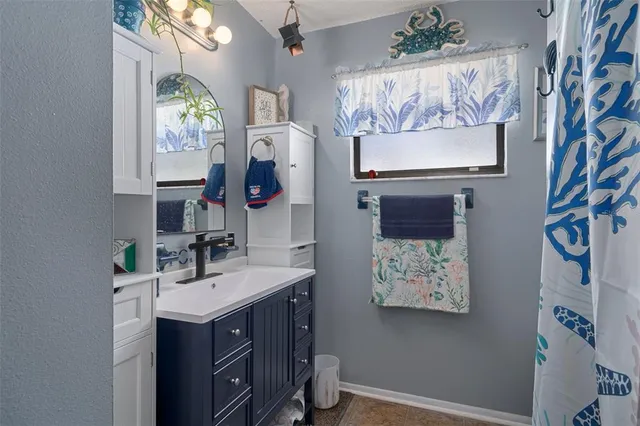 a bathroom with a double vanity sink mirror and bathtub
