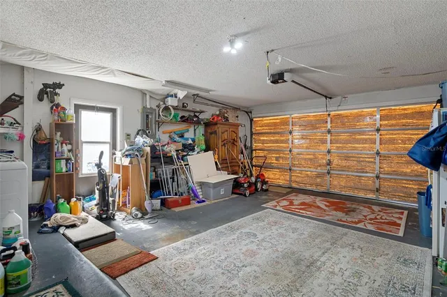 a view of storage and utility room with fridge and workspace