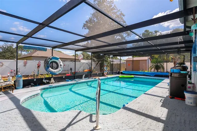 a view of a backyard with table and chairs under an umbrella