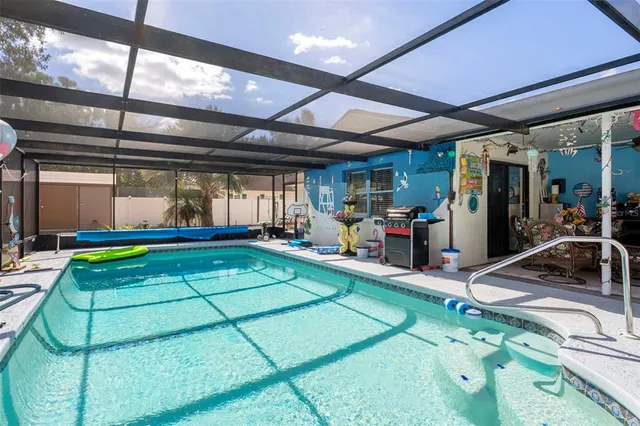 a view of a house with swimming pool and sitting area