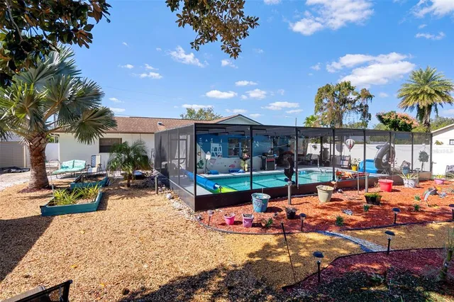 a view of a swimming pool with outdoor seating