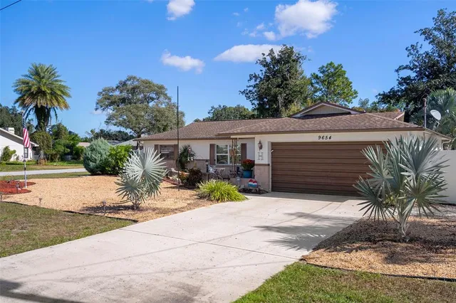 a view of house with outdoor space and trees