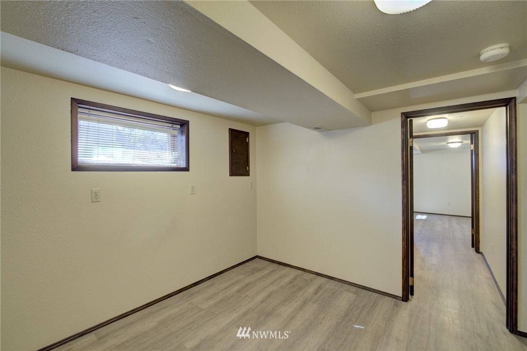 121 Logan Avenue South Renton, WA 98057 - Photo 16 of 25 an empty room with wooden floor and windows