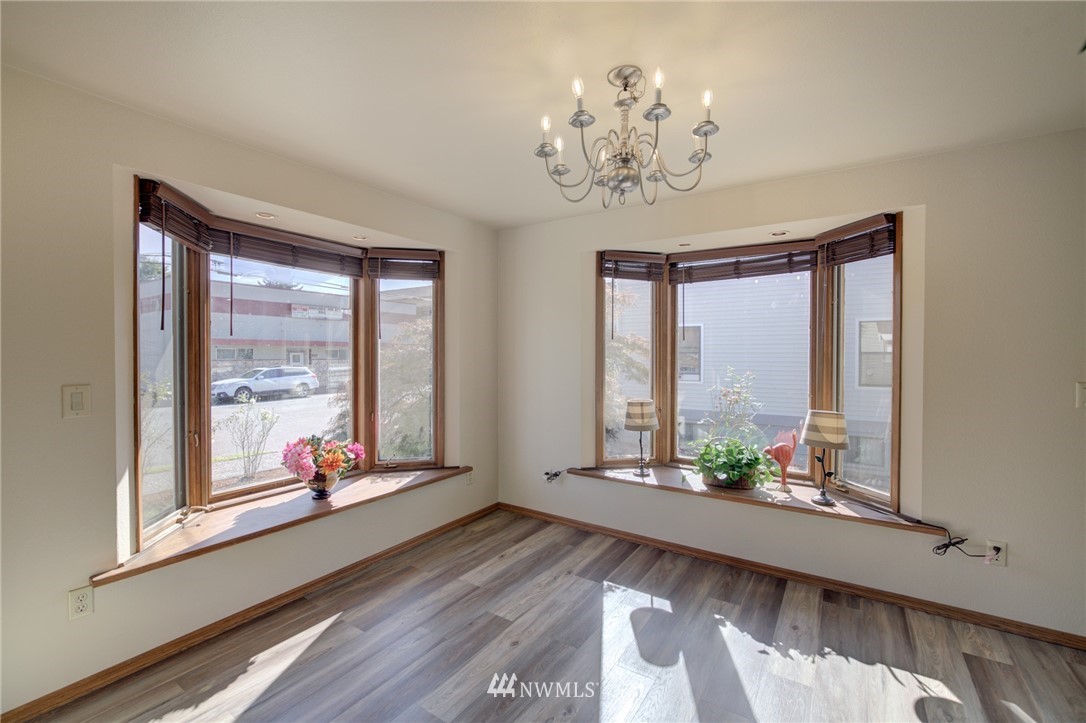 121 Logan Avenue South Renton, WA 98057 - Photo 3 of 25 a view of an empty room with wooden floor and a large window