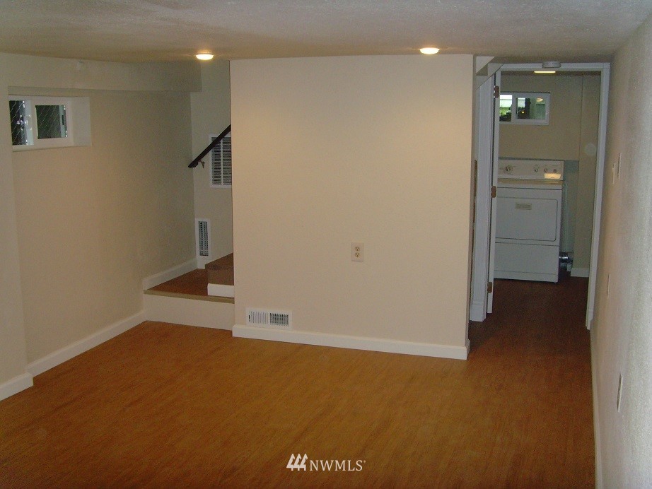 121 Logan Avenue South Renton, WA 98057 - Photo 23 of 25 an empty room with wooden floor and windows