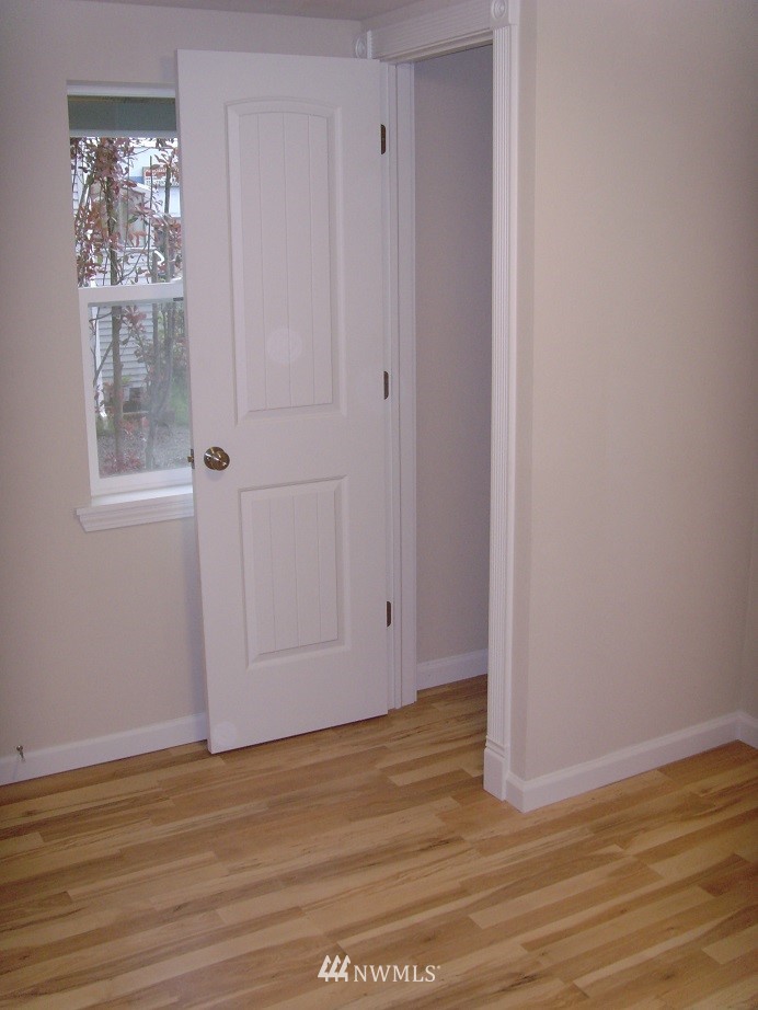 121 Logan Avenue South Renton, WA 98057 - Photo 24 of 25 a view of an empty room with wooden floor and a window