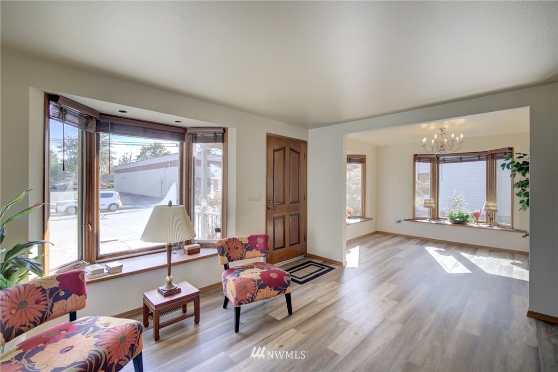 121 Logan Avenue South Renton, WA 98057 - Photo 4 of 25 a living room with furniture and floor to ceiling windows