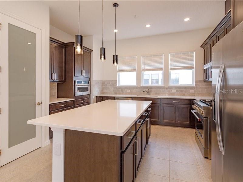 2353 Brix Street Orlando, FL 32804 - Photo 13 of 25 a kitchen with stainless steel appliances granite countertop a refrigerator a sink a stove and a oven