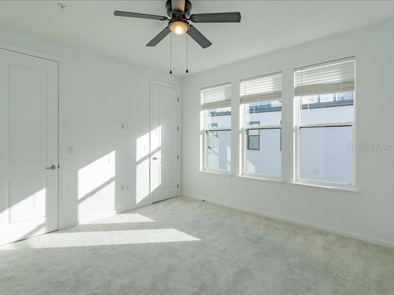 2353 Brix Street Orlando, FL 32804 - Photo 20 of 25 an empty room with windows and fan