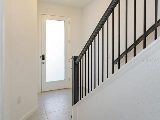 a view of staircase with lots of frames on wall